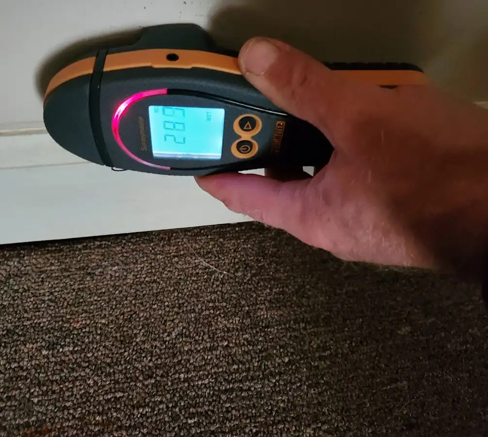 Moisture detection at baseboard during Storm Damage Restoration in Plainfield